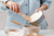 Woman mixing flour and water together in a mixing bowl.